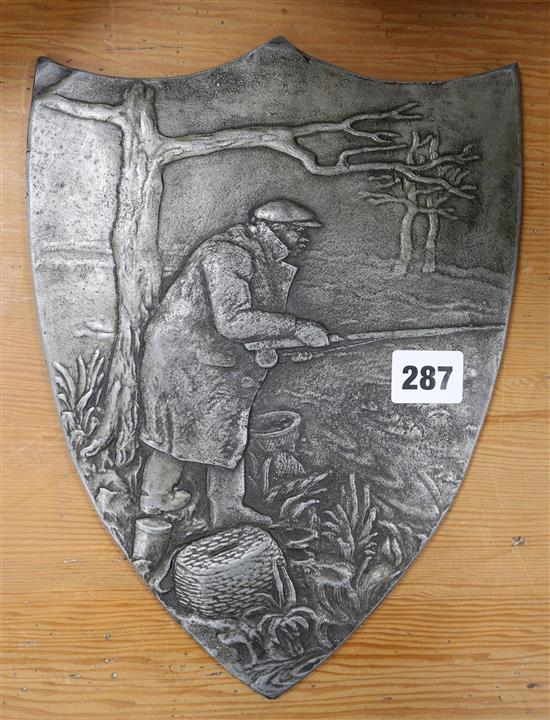 A metal plaque of fisherman with reel